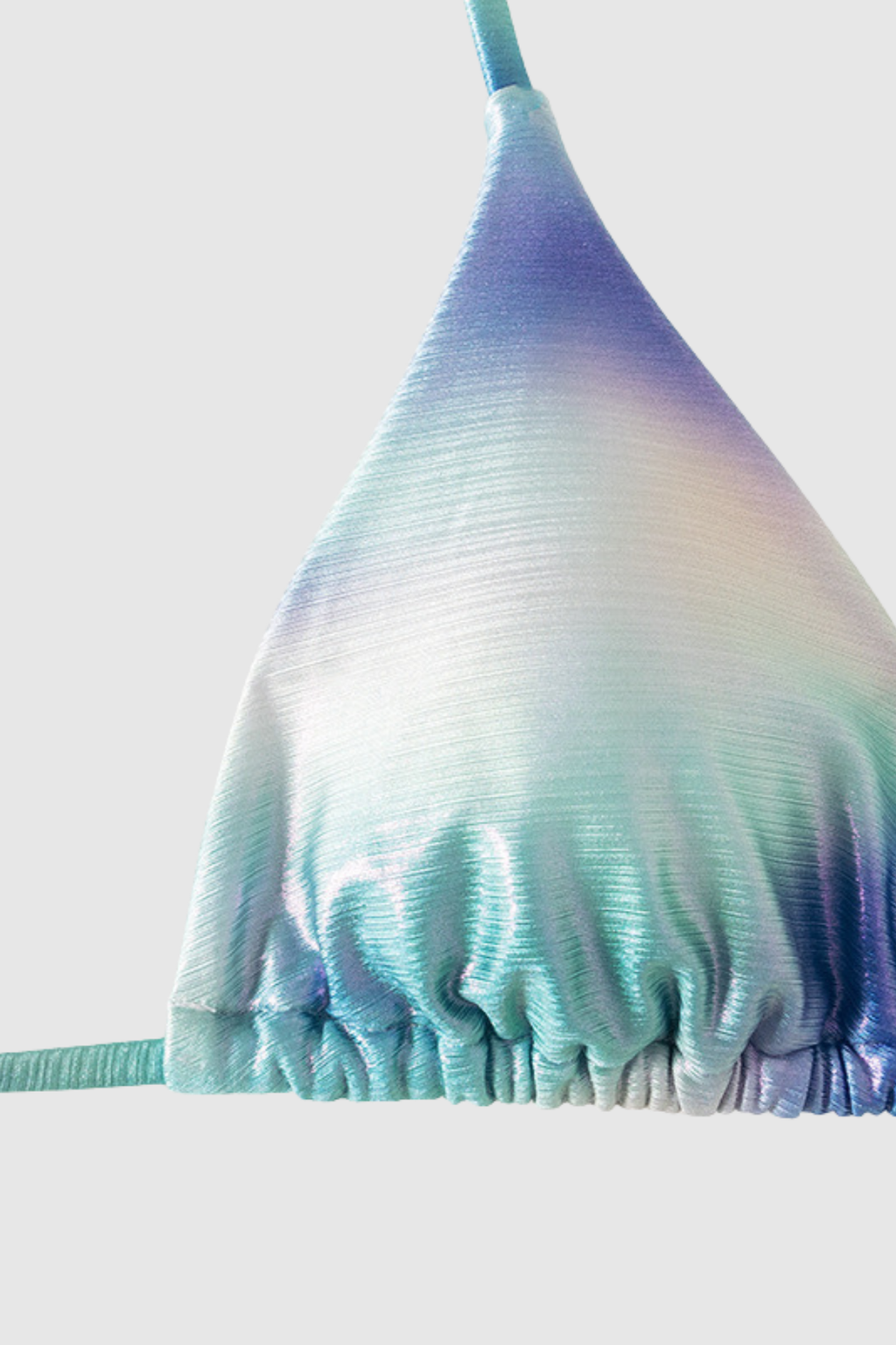 Close up of metallic fabric with blue to silver gradient sheen and smooth texture