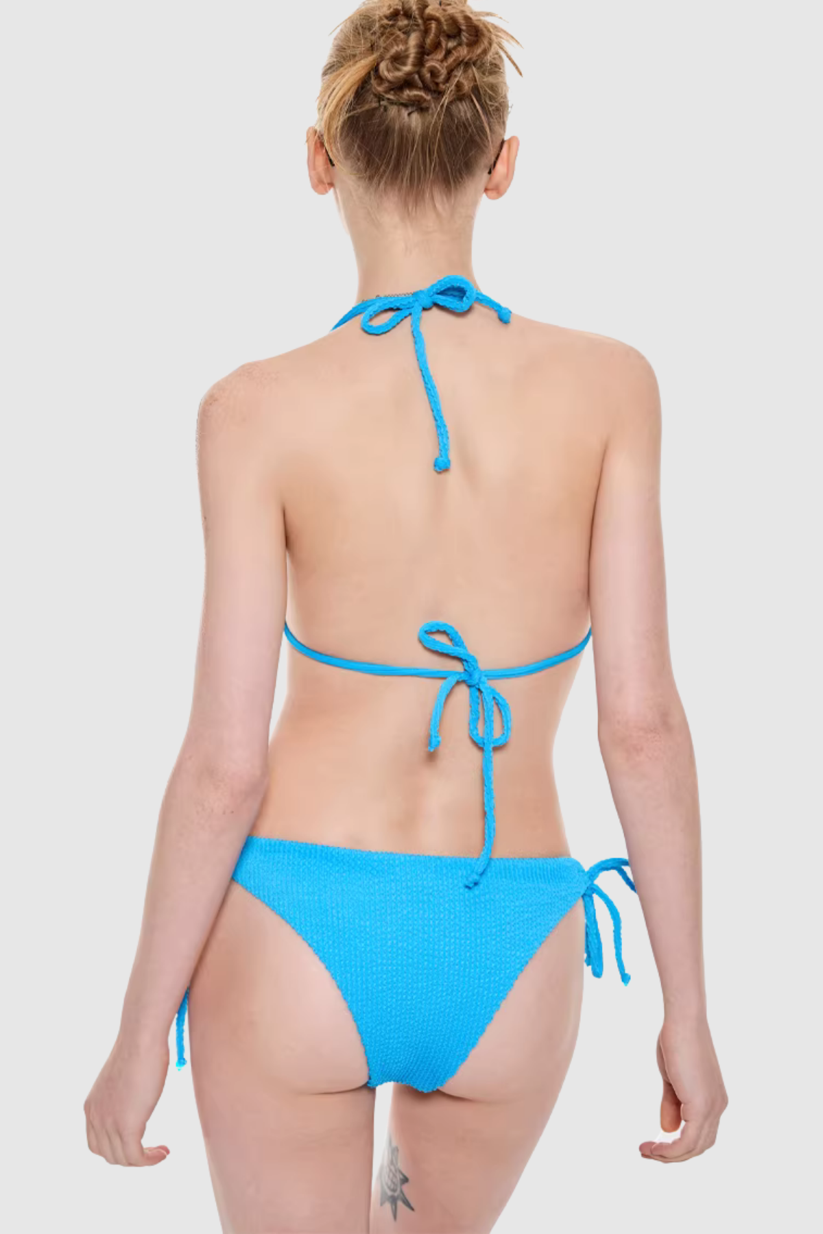 Back view of Saige swimwear showing open back bikini and flowy white cover-up